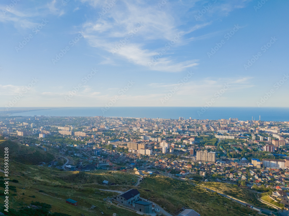 Landscape made from the mountain of Makhachkala city in Russia with a clear blue sky above the ocean. 
