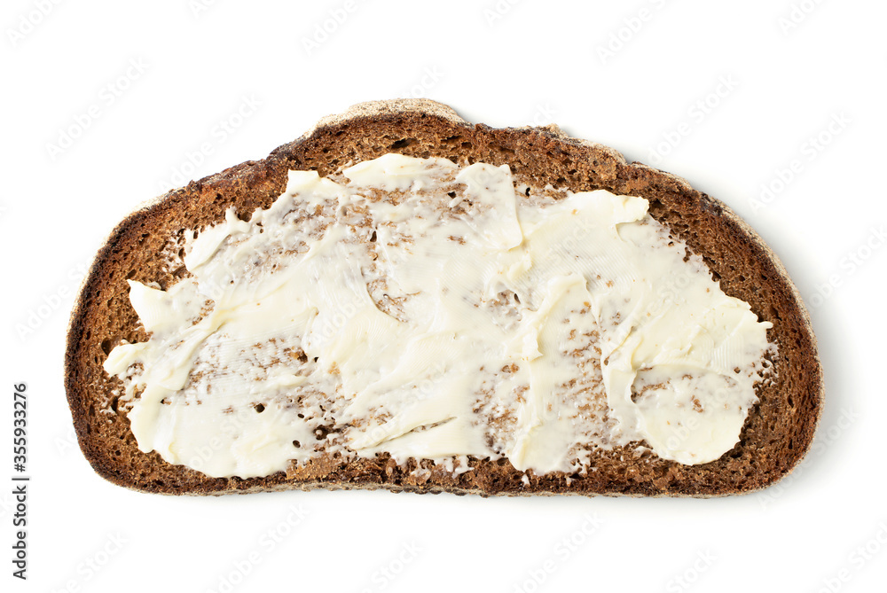 A slice of black rye bread spread with butter on a white background. Isolated object, a concept for culinary design. A slice of black rye bread spread with butter on a white background. Isolated object, a concept for culinary design.