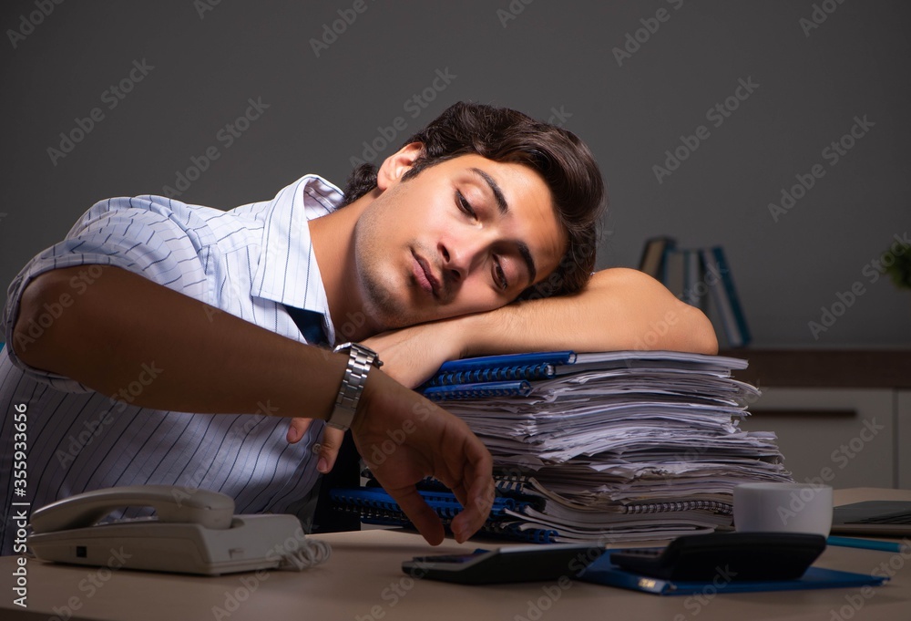Young financial manager working late at night in office Young financial manager working late at night in office