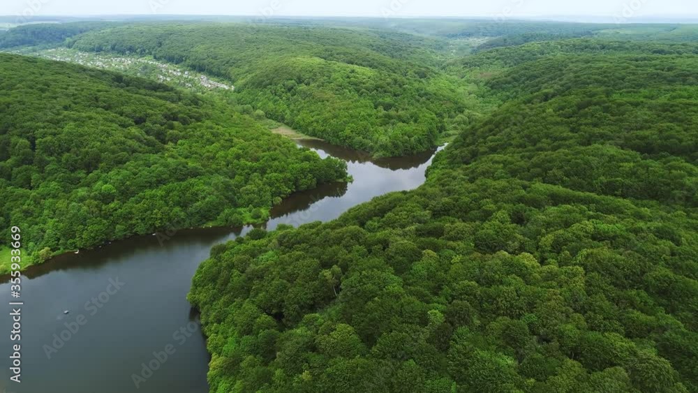 Aerial view of green forest and river in Ukraine. Flying Over the Beautiful Summer River. Aerial Camera Shot Aerial view of green forest and river in Ukraine. Flying Over the Beautiful Summer River. Aerial Camera Shot