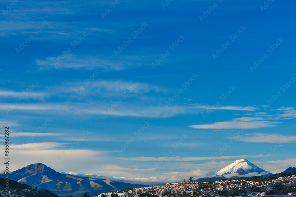 The city of Quito surrounded by the Sincholagua and Cotopaxi volcanoes