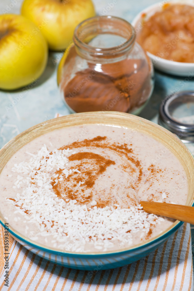 healthy linen porridge with apple and cinnamon, vertical closeup healthy linen porridge with apple and cinnamon, vertical closeup