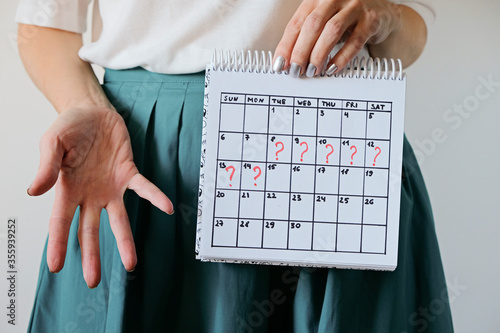 Missed period and marking on calendar. Unwanted pregnancy, woman's health and delay in menstruation. photo