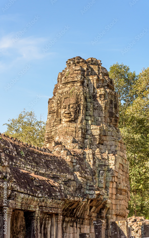 Fototapeta premium Buddha Faced Tower at the Bayon Temple at the Angkor Wat Complex in Siem Reap Cambodia