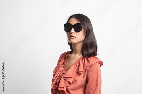 Portrait of a beautiful young asian girl in sunglasses .