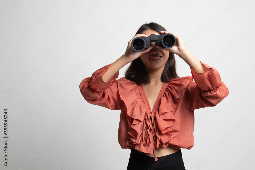Young Asian woman with binoculars . Young Asian woman with binoculars .
