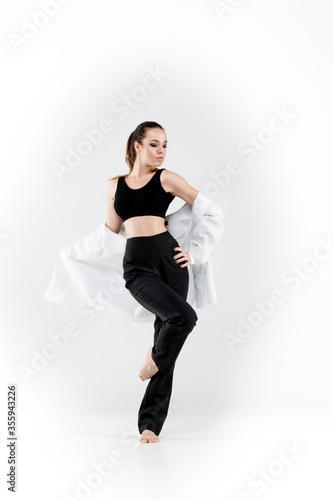 Female dancer in dance jazz poses on a white background. Jazz, modern, freedom, feelings, sport, figure, dance. 