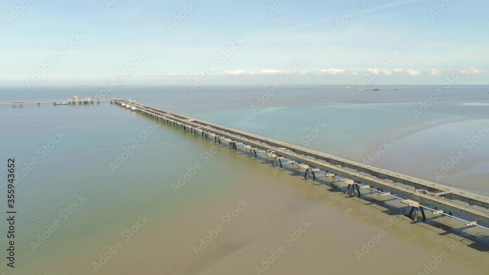 Drone Aerial View of Concrete Oil Pier Construction Above Shallow Water of North Sea Drone Aerial View of Concrete Oil Pier Construction Above Shallow Water of North Sea