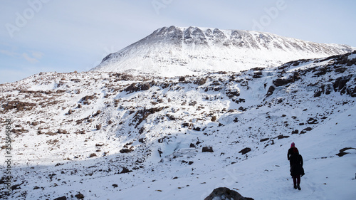 Winter mountain hiking in the snow at the Triple Buttress of Coire Mhic Fhearchair on the Isle of Skye in the Scottish Highlands of the UK. photo