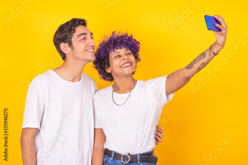 Wallpaper Mural isolated young couple smiling for photo with mobile phone Torontodigital.ca