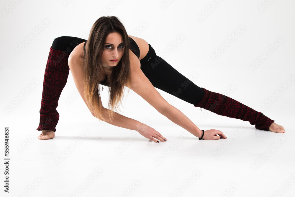 Sexy girl doing stretching on a white background. The gymnast shows the strength and flexibility of her body. Flexibility, strength, modern, stretching, classic, elegance, style, dance, exercise Sexy girl doing stretching on a white background. The gymnast shows the strength and flexibility of her body. Flexibility, strength, modern, stretching, classic, elegance, style, dance, exercise