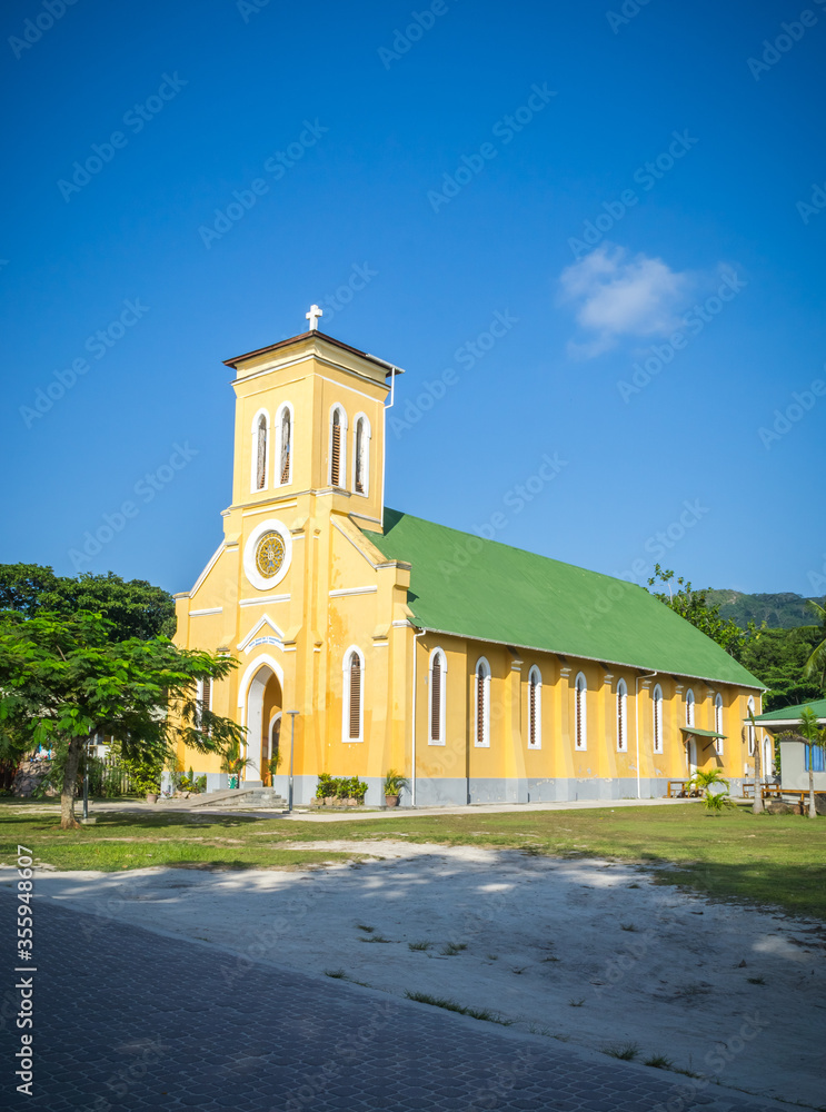 Fototapeta premium A beautiful Catholic church (St Mary's church) in the tropical nature of La digue island, Seychelles. portrait format