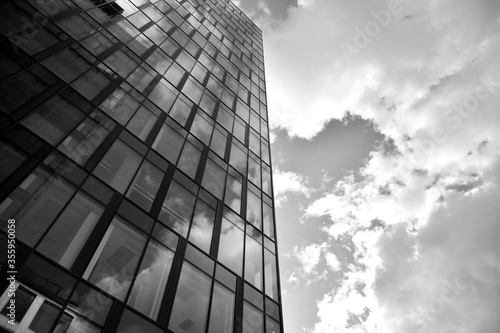 Urban geometry  looking up to glass building. Modern architecture  glass and steel. Abstract modern architecture design with high contrast black and white tone.