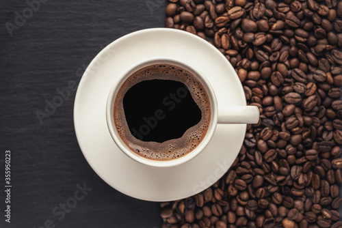 cup of coffee on a black stone surface top view