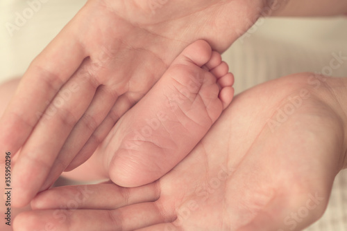 foot of a newborn baby in mom’s hands