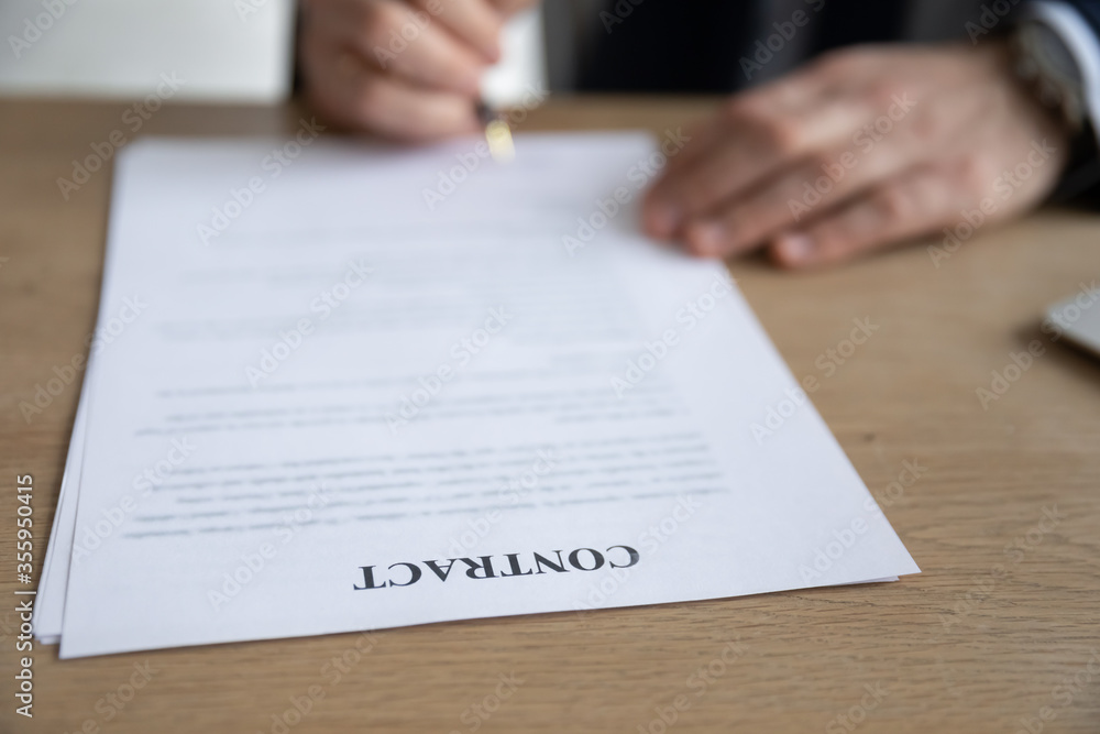 Crop close up of businessman put signature on paper document make agreement in office, male boss or CEO sign paperwork contract close deal with business partner or client, partnership concept Crop close up of businessman put signature on paper document make agreement in office, male boss or CEO sign paperwork contract close deal with business partner or client, partnership concept