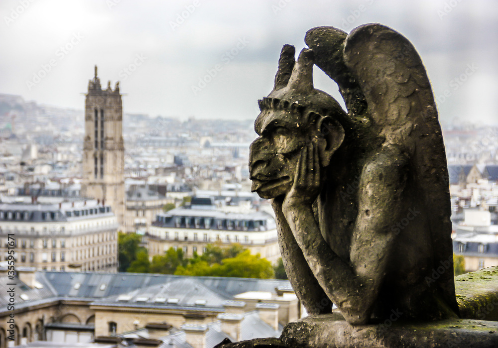 Mythical creature gargoyle on Notre Dame de Paris. View from the tower. Paris, France