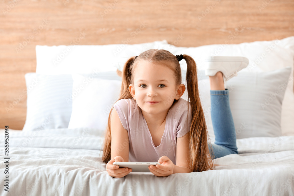 Cute little girl with mobile phone at home Cute little girl with mobile phone at home