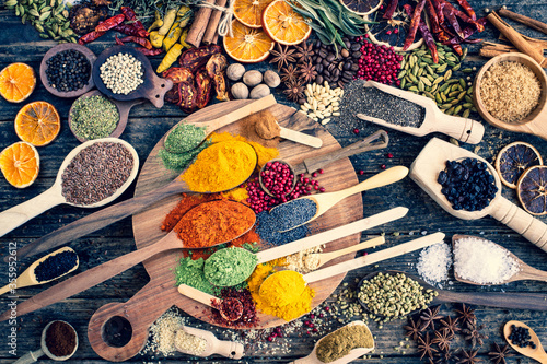 Fototapeta Naklejka Na Ścianę i Meble -  Many colorful spices, herbs and dried fruits on the wooden rustic table