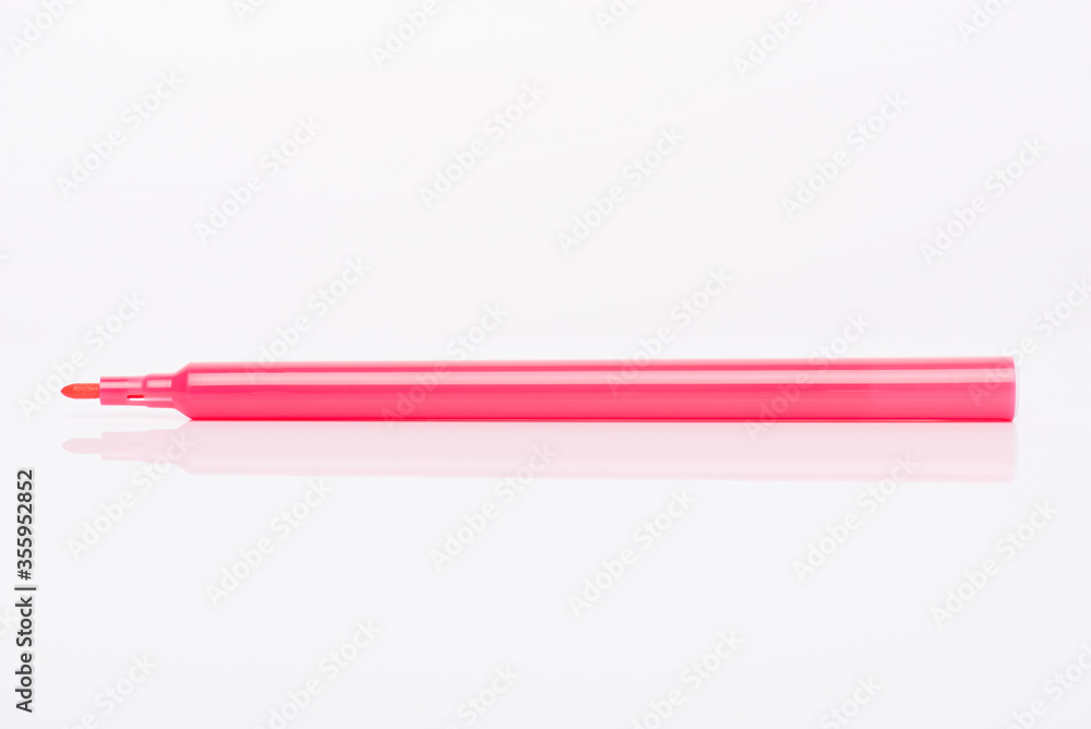Side profile view close-up photo of pink marker with cap off isolated on white background Side profile view close-up photo of pink marker with cap off isolated on white background