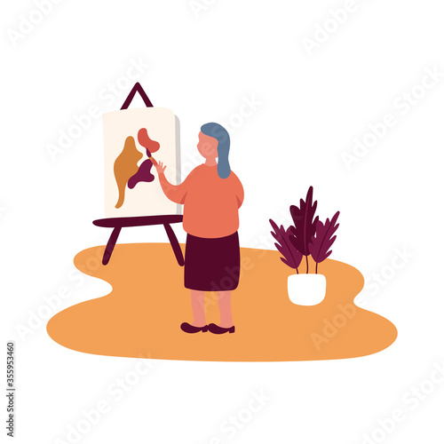 eldery woman painting picture in home activity free form style