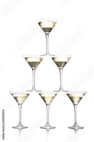Tower made of glasses with champagne on white background