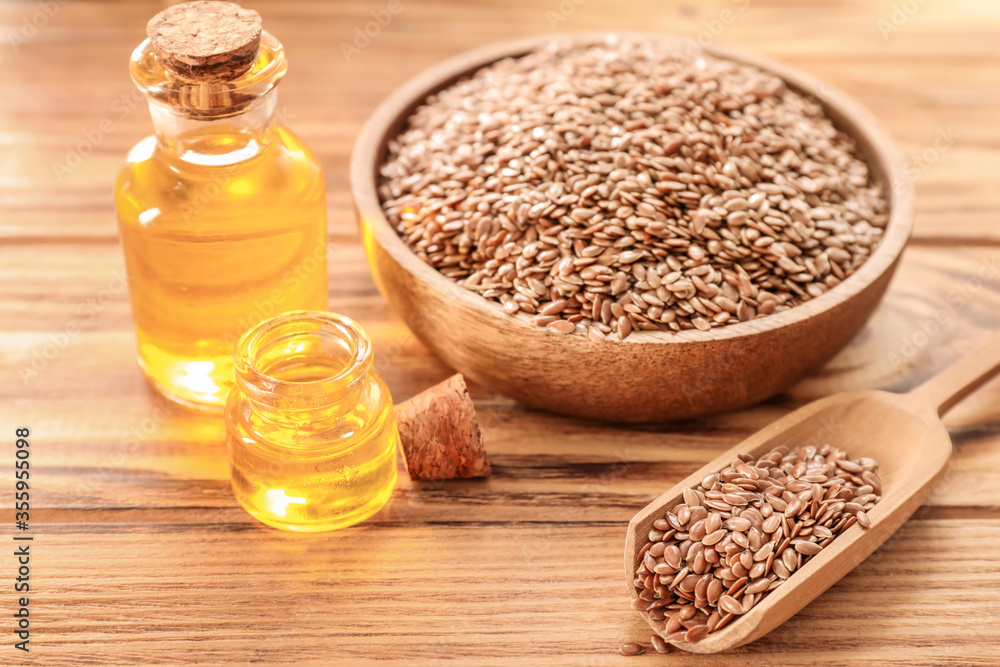 Composition with flax oil on wooden background Composition with flax oil on wooden background