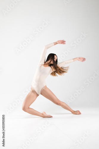 Ballerina in a dance pose on a white background. Art, style, background, elegant, expensive, luxury, amazing, modern.