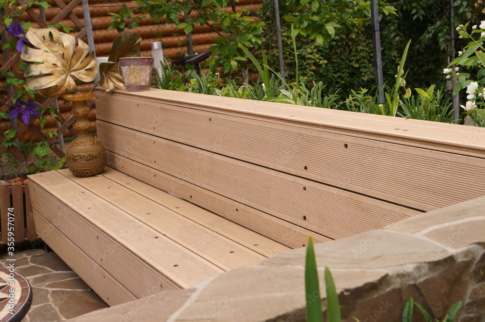 Design of a modern stone patio. Benches made of natural stone and wood