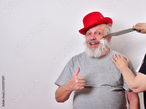 Slika na platnu Man is getting a shave with a huge bowie knife