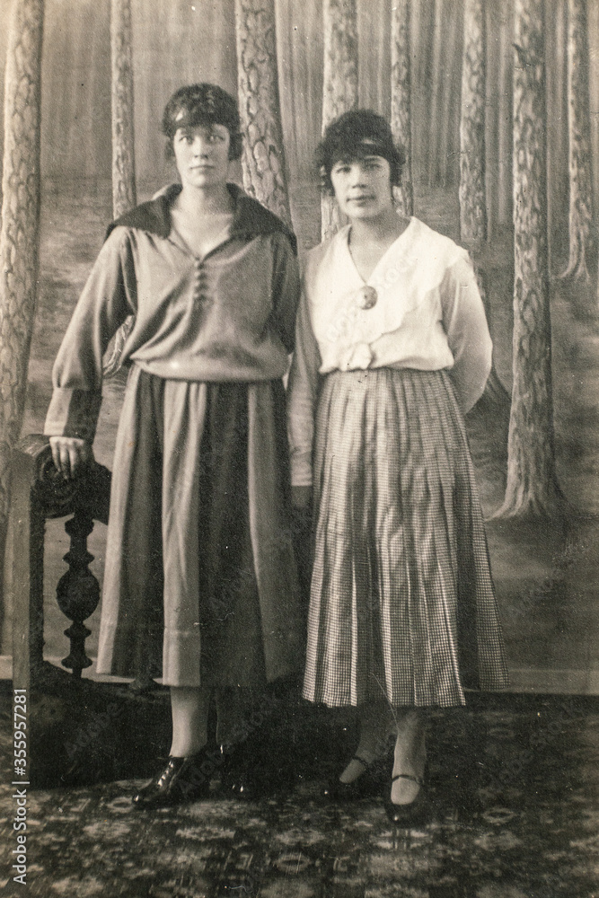 RUSSIA - CIRCA 1910s: Full body shot of two young women in studio Vintage Carte de Viste Edwardian era photo