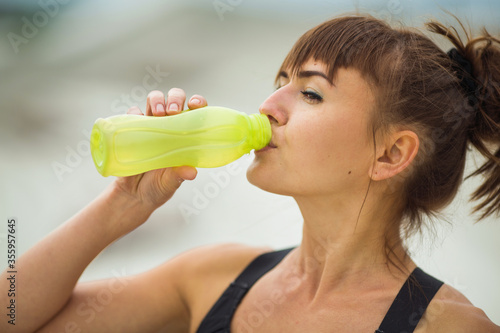 beautiful young woman with a sports figure jogging outdoors