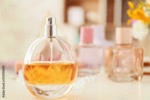 Perfume and cosmetics on table