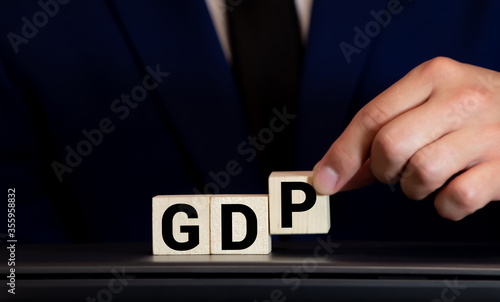 GDP, Gross Domestic Product concept, cube wooden block with alphabet combine abbreviation GDP, measure growth of country economic product and service. photo