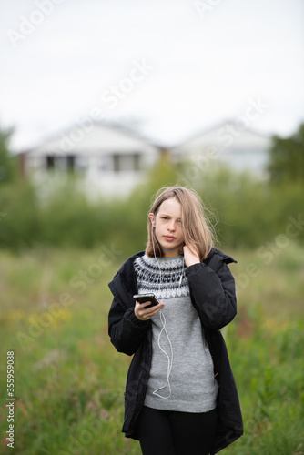 Girl with phone wearing a coat