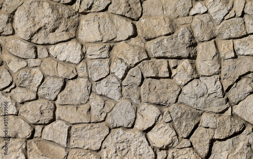 Wall made of natural rocks and concrete