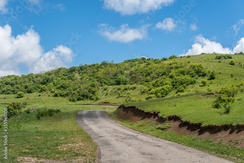 Tranquil Hilltop Landscape with Blue Sky and Clouds
