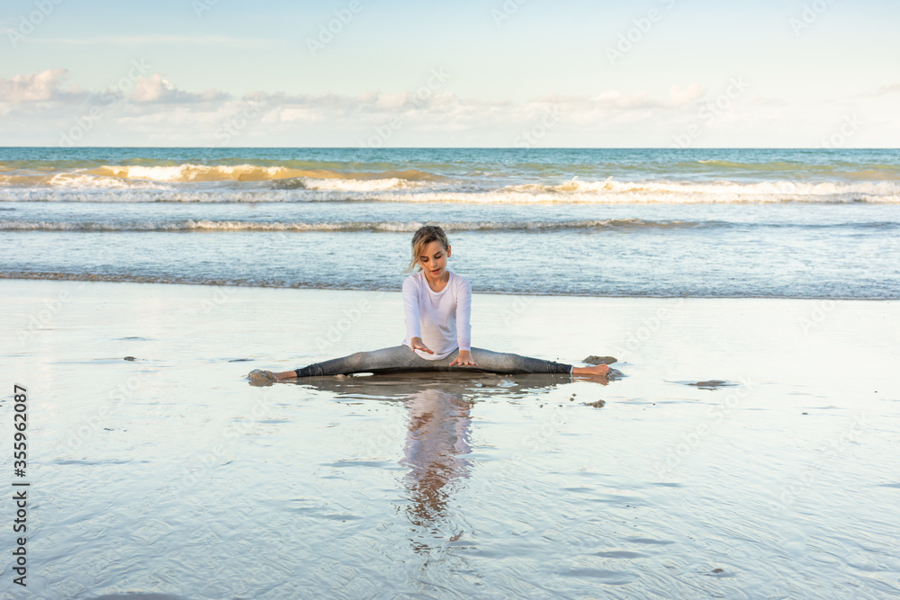 Child meditating on the beach in difficult times
