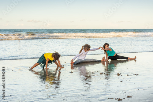 Children playing and exercising on the beach