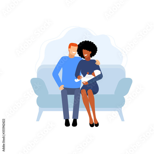 Interracial marriage.  interracial couple with baby sitting on sofa. a happy family