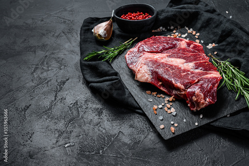 Raw beef fillet steak. Organic farm meat. Black background.