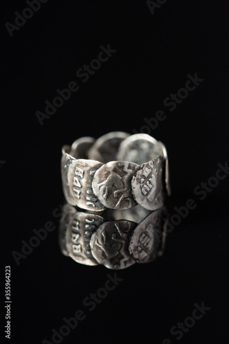 On a black background a silver ring
