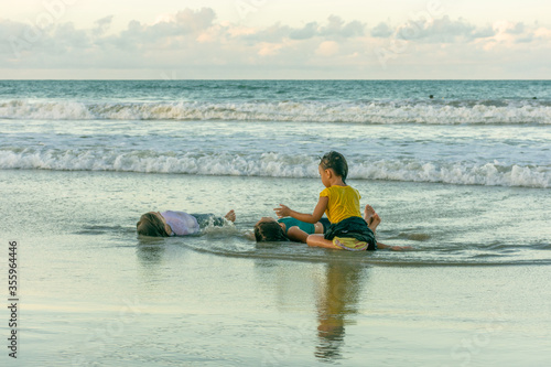 Children friends playing relaxed on the beach on a beautiful day © Rogerio