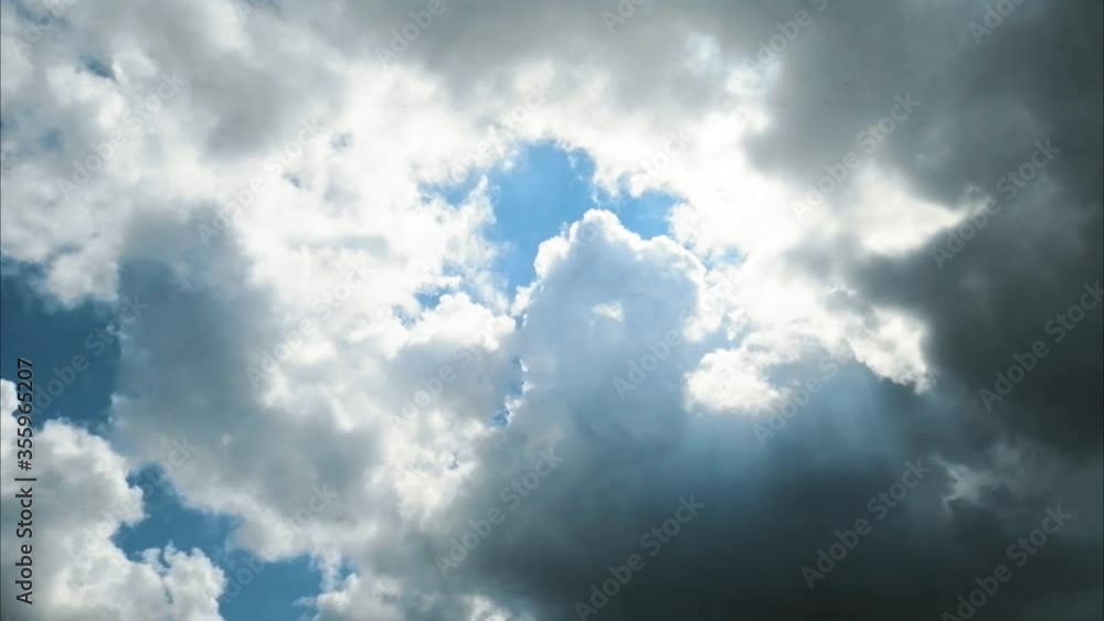 High cumulus white clouds lit by sun move across blue sky. Atmospheric flight of bright cloud. Meteorology and weather forecast. A relaxing scene. Windy climate close up. Slow motion High cumulus white clouds lit by sun move across blue sky. Atmospheric flight of bright cloud. Meteorology and weather forecast. A relaxing scene. Windy climate close up. Slow motion