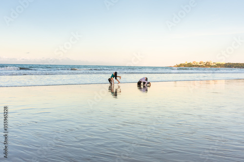 Children exercising on the beach juggling joy