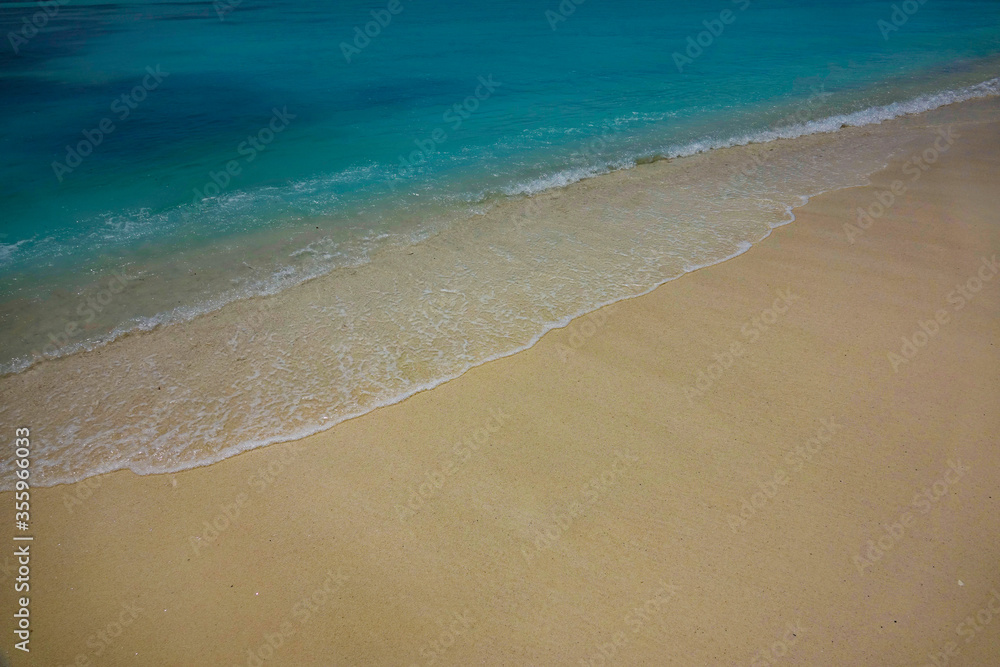 CLOSE UP: Gorgeous turquoise ocean water washes the pristine white sand beach CLOSE UP: Gorgeous turquoise ocean water washes the pristine white sand beach