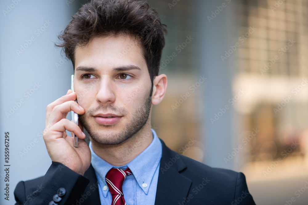Portrait of a young businessman talking on the phone Portrait of a young businessman talking on the phone