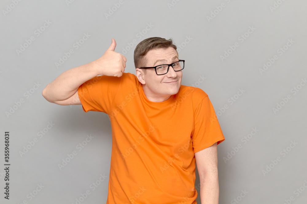 Portrait of happy man raising thumb up in approval and like gesture Portrait of happy man raising thumb up in approval and like gesture
