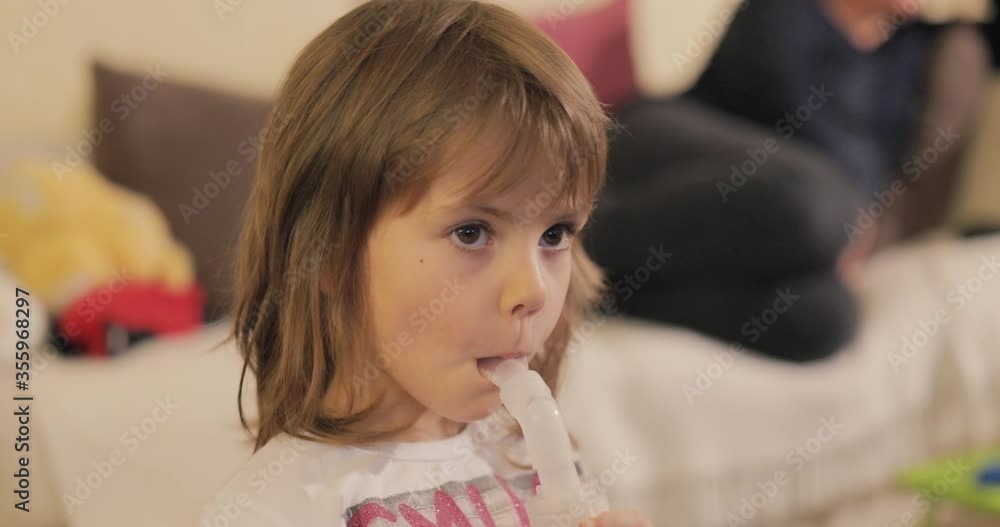 Beautiful little girl inhaling herself with a nebulizer Beautiful little girl inhaling herself with a nebulizer