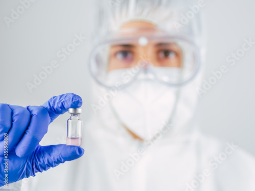 Doctor wearing face mask, protection glasses and PPE suit for Coronavirus.